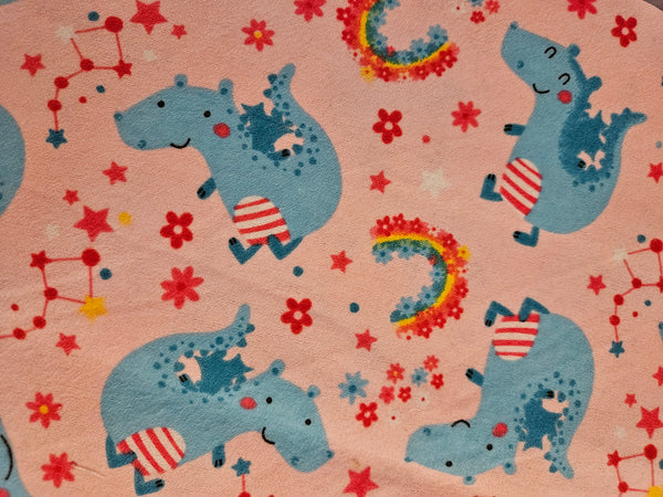 Rainbows and dinos. Stars on pink background. Flannel and terry cloth