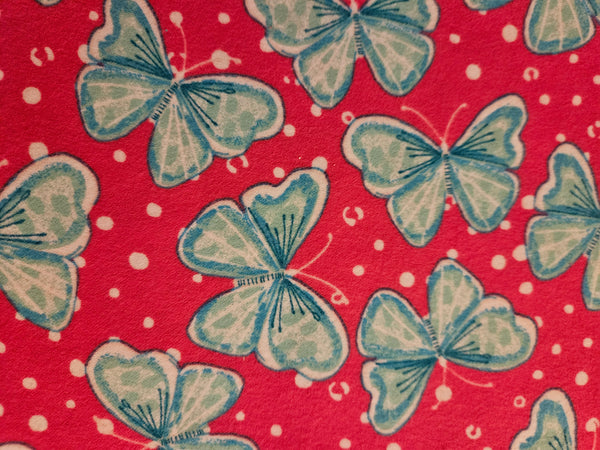 Blue butterflies with bright pink background. Flannel and terry cloth